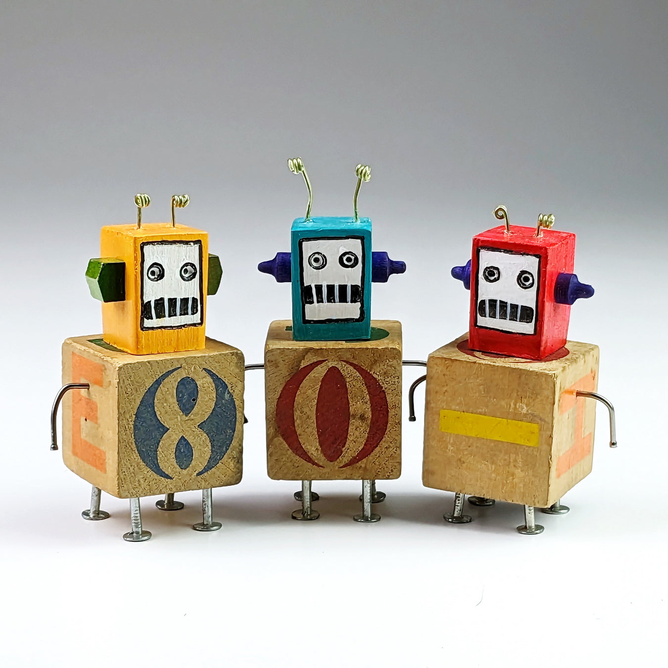 3 figures created with vintage wooden blocks